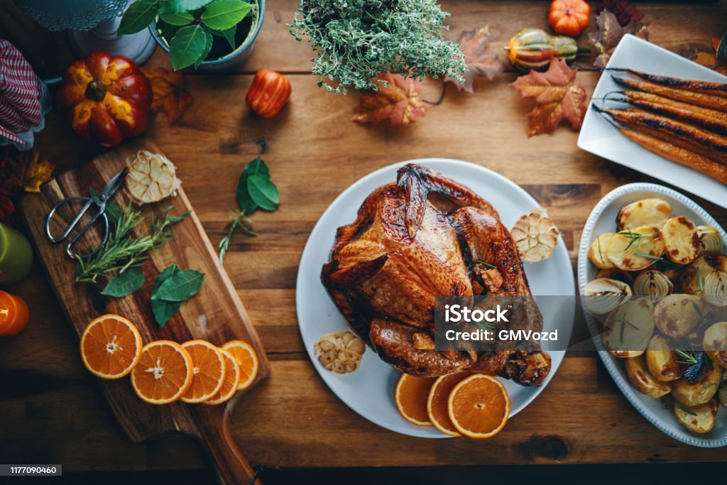 Preparing Stuffed Turkey for Holidays in Domestic Kitchen Preparing Stuffed Turkey with Vegetables and Other Ingredients for Holidays Thanksgiving - Holiday Stock Photo