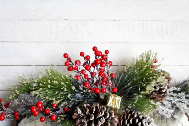 istock rustic winter decoration with pine, gift and berries on white wooden background, copy space 1177090565