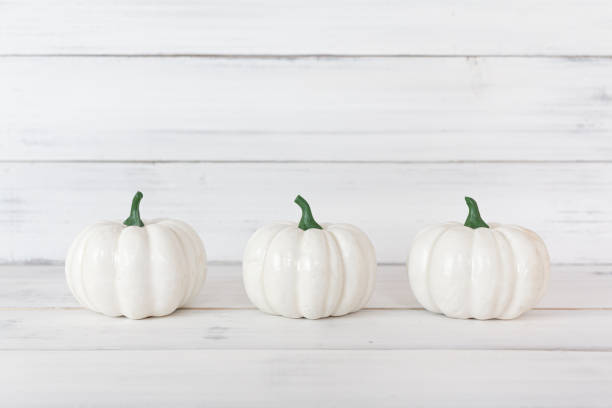 istock White pumpkin on white wood table with copy space. 1177090892