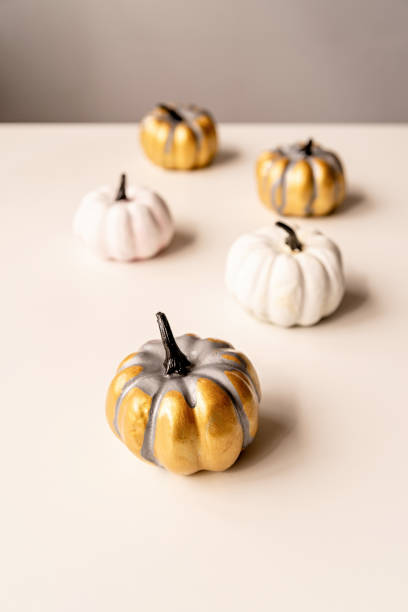 istock colorful painted pumpkins on white table with copy space 1177092791