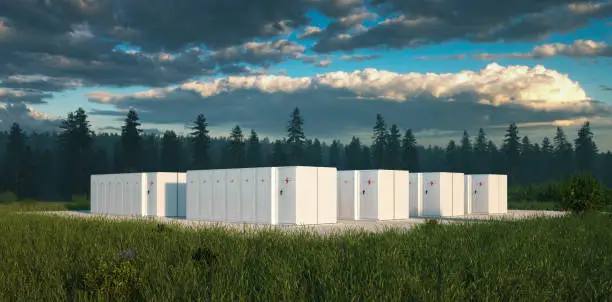 Photo of Eco friendly battery energy storage system in nature with misty forest in background and fresh grassland in foreground. 3d rendering.