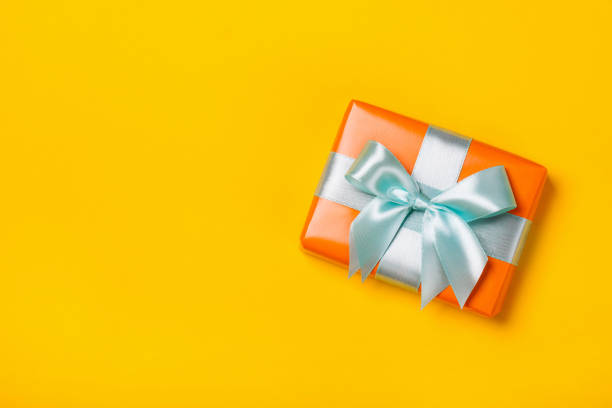 istock Attractive gift on a fashionable yellow background 1177098051