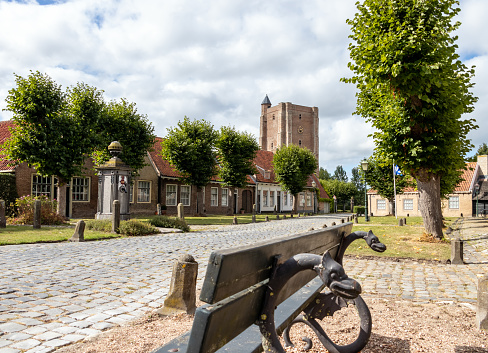 View of the market square of an old medieval village in the province of Zeeland in the Netherlands, a church tower is visible in the background