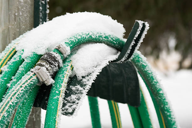 Frozen Garden Hose Garden hose covered with snow and frost. garden hose photos stock pictures, royalty-free photos & images