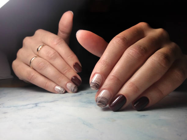istock Beautiful dark brown nails with spider web and glitter design. Chocolate gel lacquer with geometric design. 1177100517