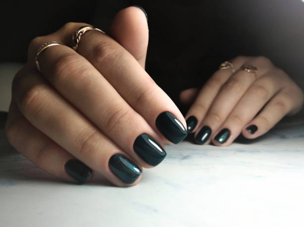 istock Short square nails emerald color. Dark color coating with sequins. 1177100524