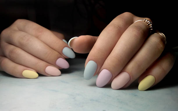 istock Colorful manicure with multi-colored coating. Long round nails with color matte design. 1177100536