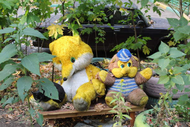 istock stuffed toys bear and Fox in the Park on a bench 1177102563