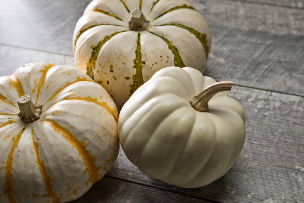 istock Autumn White pumpkins on wood background 1177104997
