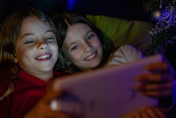 istock Two pretty girls playing with a digital tablet 1177106419