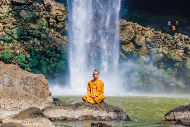 istock Monk under the Phu Chong waterfall in Vietnam 1177106618