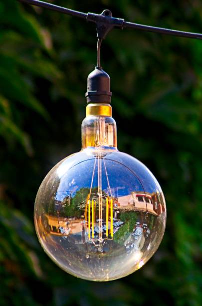 istock Retro style lightbulbs in a beautiful mediterranean restaurant on a sunny summer evening 1177107570