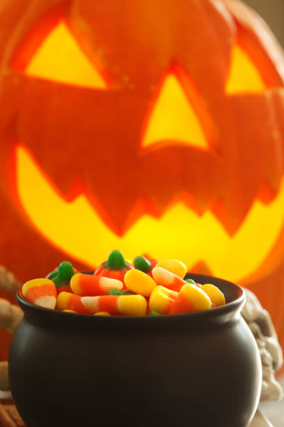 istock Pot Of Halloween Candy In Front Of A Jack O'Lantern 1177107648