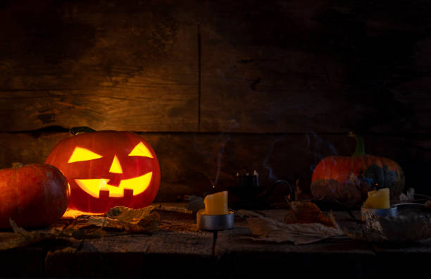 istock Halloween pumpkins head jack o lantern on wooden table background 1177109455