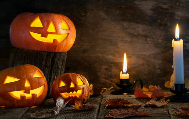 istock Halloween pumpkins head jack o lantern on wooden table background 1177109488