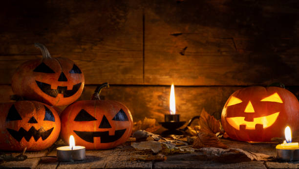 istock Halloween pumpkins head jack o lantern on wooden table background 1177109500