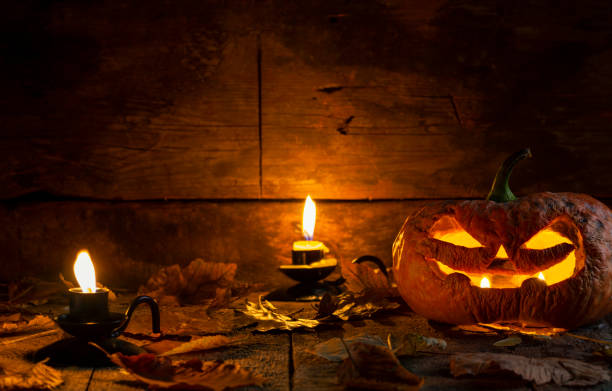 istock Ugly Halloween pumpkin head jack o lantern on wooden table background 1177110043