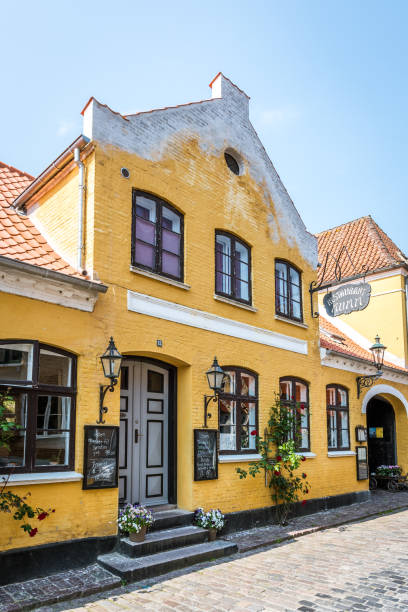 Restaurant Mumm, an old yellow stone house with red roses in Aeroskobing, Denmark, July 13, 2019July 13, 2019