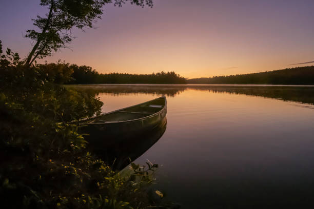 istock Canoe rests on glassy water at dawn 1177111833