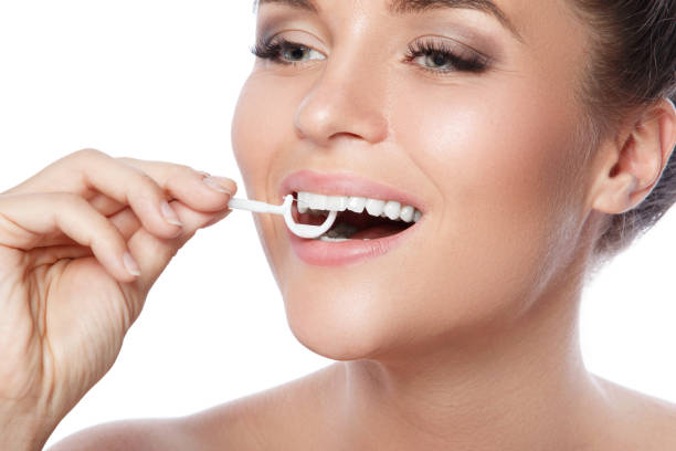 Woman and dental floss pick stock photo