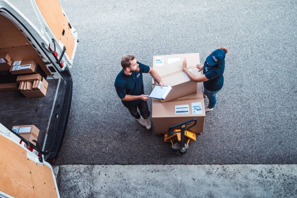 istock Coworkers rushing to load packages in a delivery van 1177117384