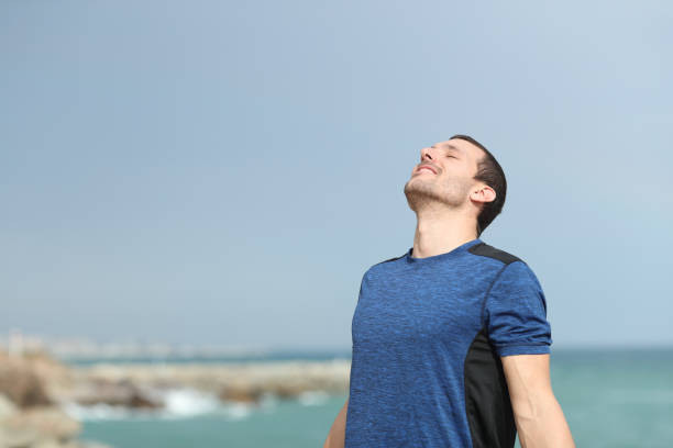 istock Happy runner breathing fresh air on the beach before sport 1177118502