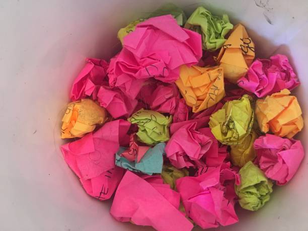 istock Bucket of crumpled post its colorful white background 1177121576