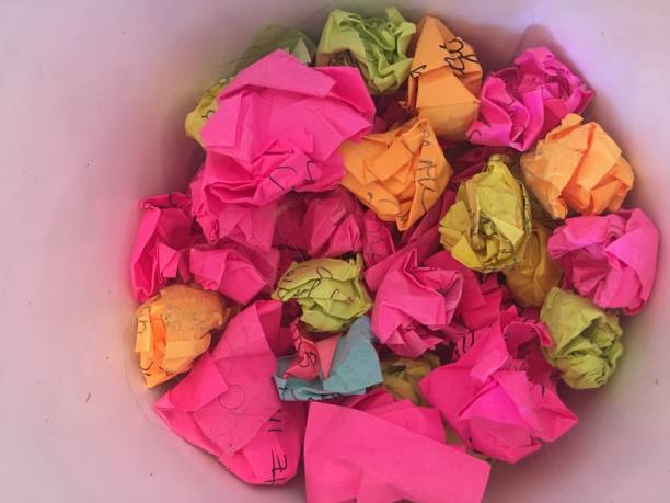 istock Bucket of crumpled post its colorful white background 1177121582