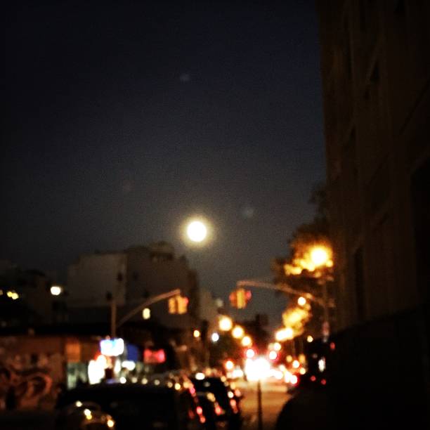istock Full Moon over Busy City Street 1177121640