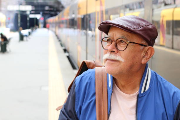Senior Hispanic man at train station
