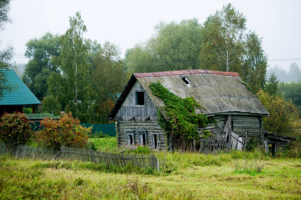 istock rickety old house in a distant village. Plot covered with grass 1177122369