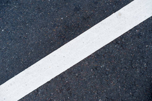 istock diagonal white marking line on asphalt 1177122407