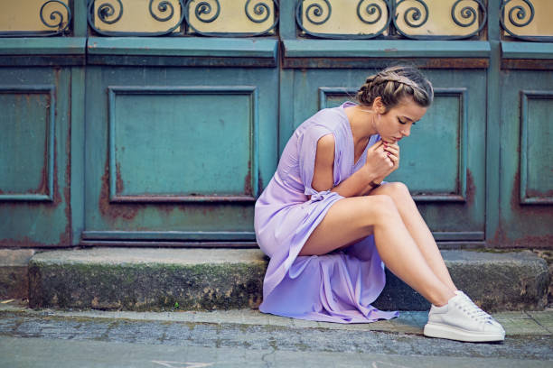Beautiful desperate girl is sitting sad