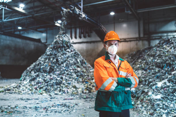istock Worker at recycling center wearing protective mask and helmet 1177130876