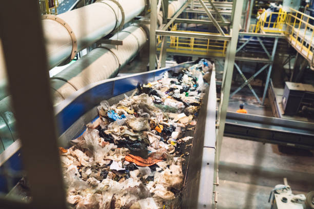 istock Waste loaded on a conveyor belt at recycling center 1177130886