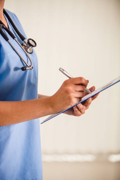 istock Unrecognizable nurse writing a diagnosis in a medical chart 1177131170