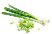 Whole and chopped green onions isolated on white background