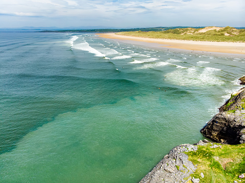 Spectacular Tullan Strand, one of Donegal's renowned surf beaches, framed by a scenic back drop provided by the Sligo-Leitrim Mountains. Wide flat sandy beach in County Donegal, Ireland.