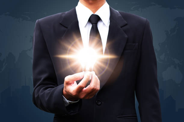 istock Idea thinking concept,Businssman holding holding illuminated light bulb on world map background. 1177141398