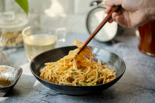 Chinese homemade noodles:spicy noodles stirred with shredded chicken meat stock photo