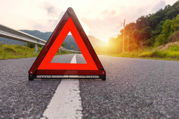 Red triangle, red emergency stop sign, red emergency symbol on road. With copy space for text or design Red triangle, red emergency stop sign, red emergency symbol on road. With copy space for text or design reflector stock pictures, royalty-free photos & images