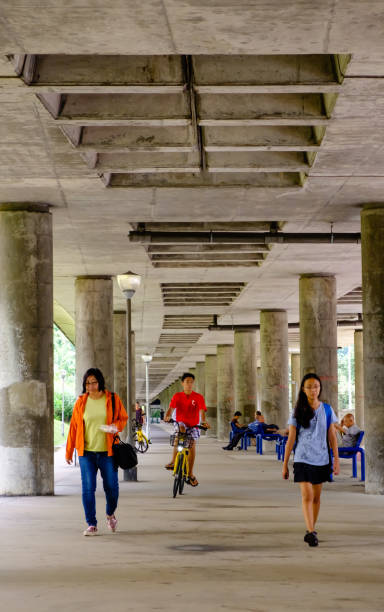 Singapore-08 SEP 2018:people walk in the open space under the mrt railway day view Singapore-08 SEP 2018:people walk in the open space under the mrt railway singapore mrt stock pictures, royalty-free photos & images