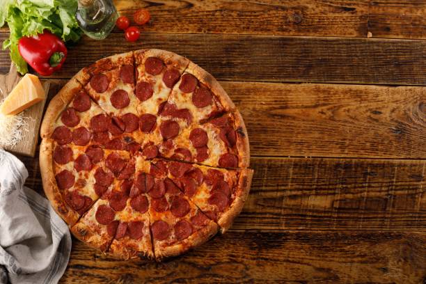 istock Pepperoni pizza on a wooden table. Still life with ingredients. Top view. Copy space. 1177154778