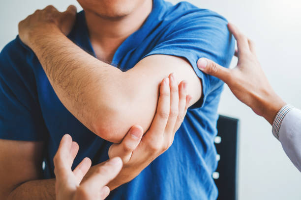 istock Physical Doctor consulting with patient About elbow muscule pain problems Physical therapy diagnosing concept 1177154910