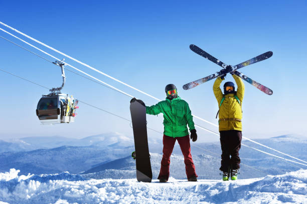 istock Snowboarder and skier in mountains 1177155576