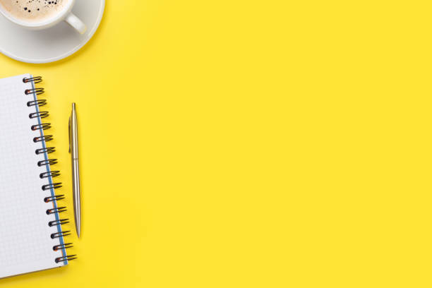 istock Office yellow workplace with coffee cup and supplies 1177155636