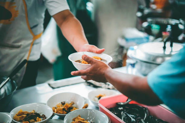 istock Philanthropists donate food and help the poor : concept of feeding 1177156888