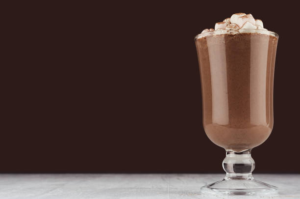 istock Christmas beverage - hot chocolate with marshmallows, cocoa powder in elegant dark brown interior, copy space. 1177162082