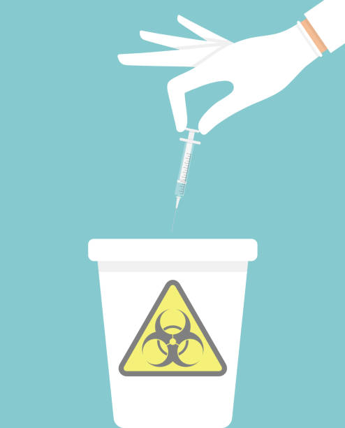 Hand holding and throwing away used hypodermic needle Hand holding and throwing away used hypodermic needle into a trash bin with biohazard sign on it medical alarm stock illustrations