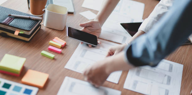 istock Close-up view of passionate UX web designer team planing interface project together 1177165139